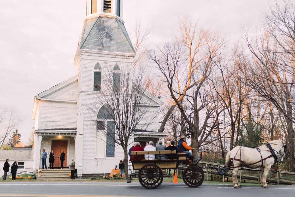 Guests arriving by horse and carriage in Vernon Center